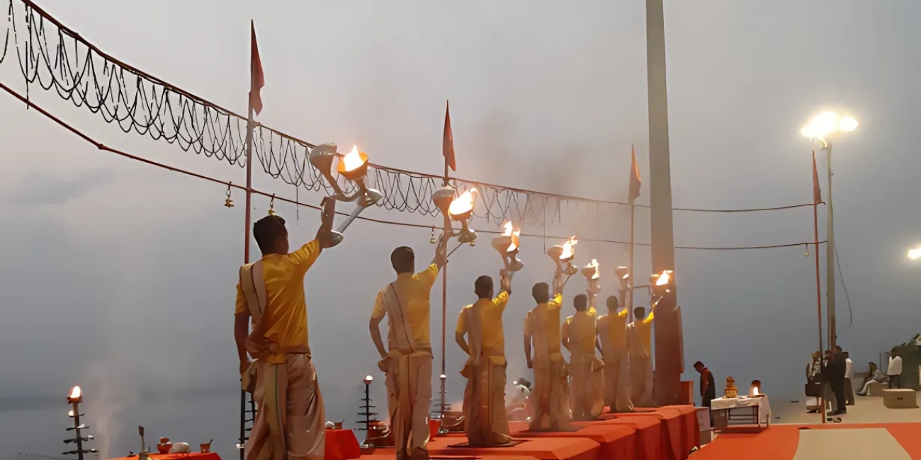 priests performing morning ganga aarti in synchronised movements at assi Ghat