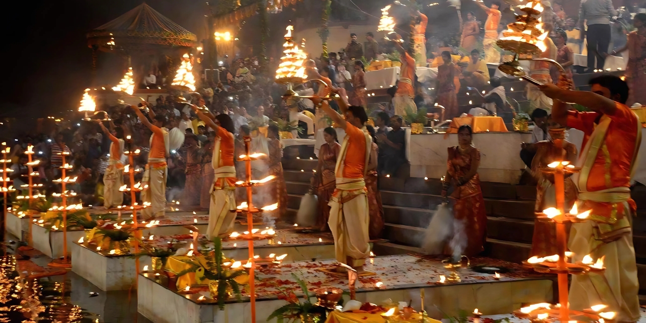 priests performing evening ganga aarti in synchronised movements on Dev Deepawali at vanaras